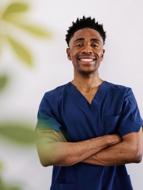 Confident Black Male Healthcare Worker in Blue Scrubs