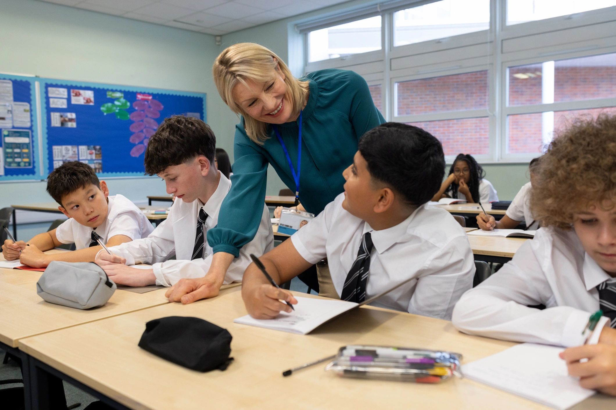 Adult learners in a classroom receiving academic support