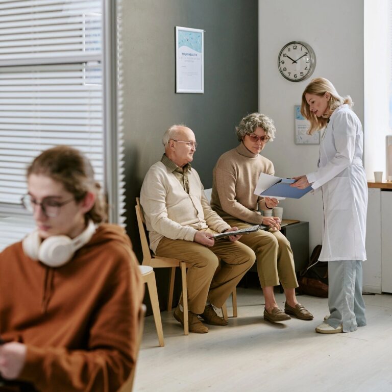 Doctor Consulting Senior Patients in Clinic Waiting Room