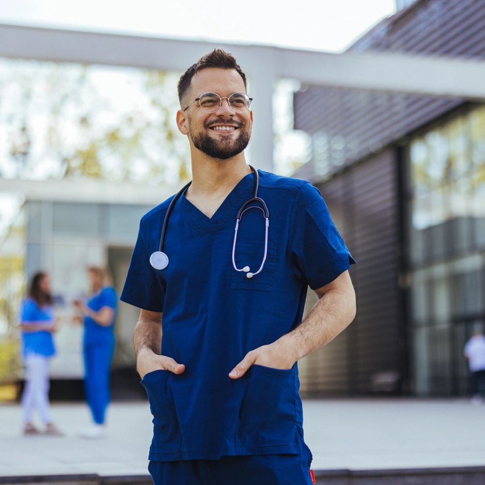 Portrait of a young medical practitioner standing with his arms crossed in a hospital.
